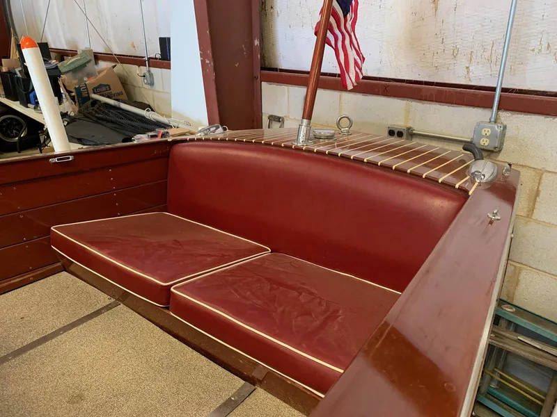 Slide: The Image of 1947 Chris-Craft 17 Runabout Deluxe with red leather seating and American flag. - 14