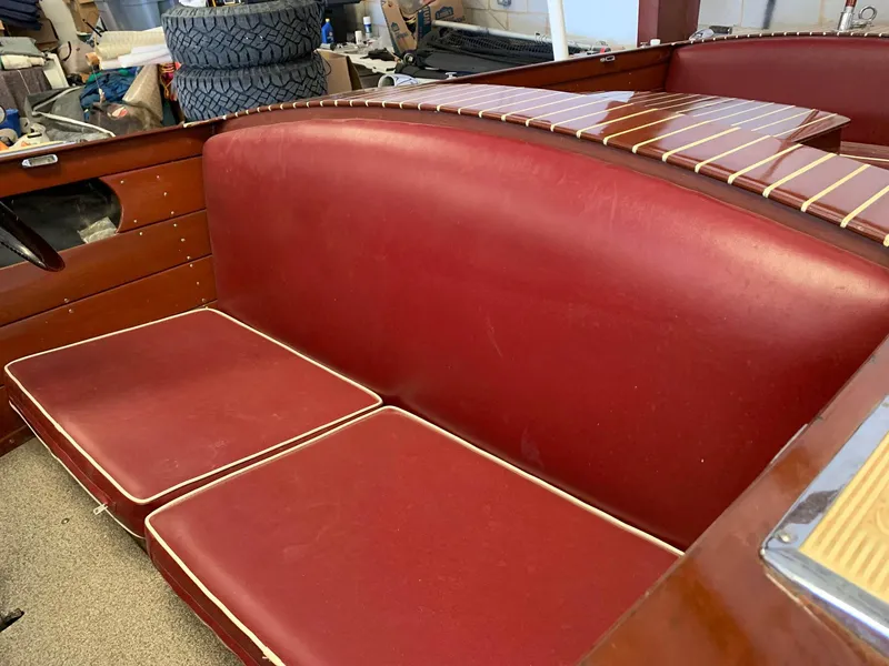 Slide: The Image of 1947 Chris-Craft 17 Runabout Deluxe with red leather seating and wooden interior details. - 15