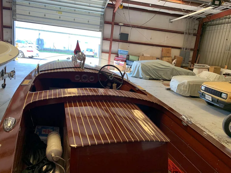Slide: The Image of 1947 Chris-Craft 17 Runabout Deluxe in a garage, showcasing classic wooden design. - 21