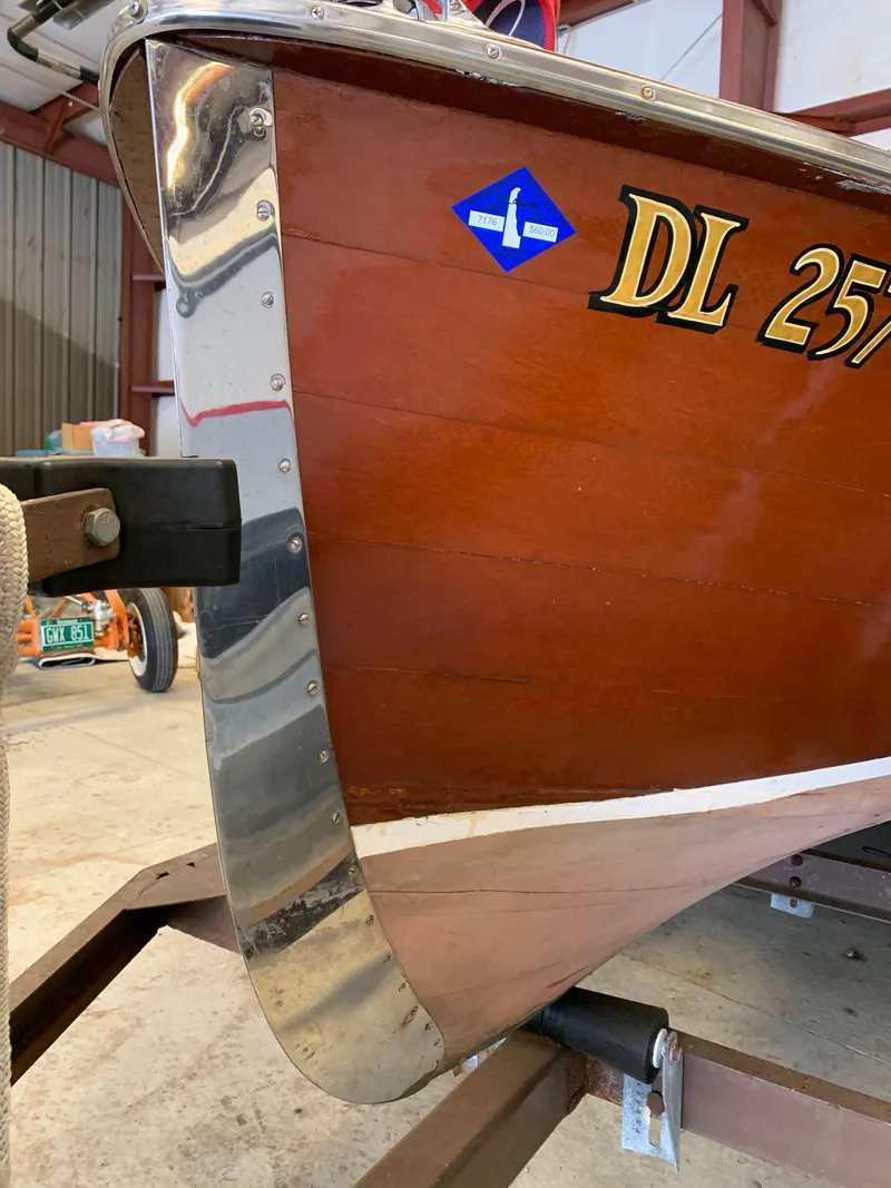 Slide: The Image of 1947 Chris-Craft 17 Runabout Deluxe boat with wooden hull and chrome detailing. - 24