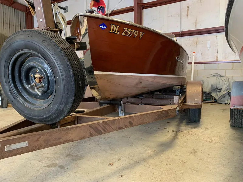 Slide: The Image of 1947 Chris-Craft 17 Runabout Deluxe on trailer in storage facility. - 25