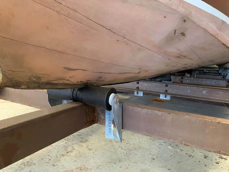 Slide: The Image of 1947 Chris-Craft 17 Runabout Deluxe boat underside on trailer, showcasing hull and support structure. - 26