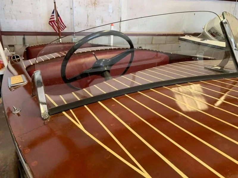 Slide: The Image of 1947 Chris-Craft 17 Runabout Deluxe, classic wooden boat interior with steering wheel and American flag. - 5