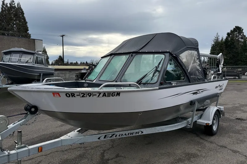 The Image of 2019 Fish Rite Stalker boat on trailer, parked outdoors under cloudy sky. - 25