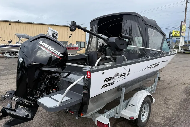 Slide: The Image of 2019 Fish Rite Stalker boat with Mercury engine on trailer, parked outdoors. - 28
