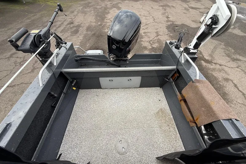 Slide: The Image of 2019 Fish Rite Stalker boat interior with motor and fishing equipment. - 31