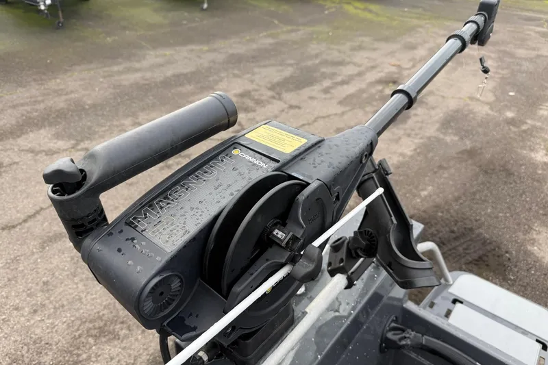 Slide: The Image of 2019 Fish Rite Stalker boat with Cannon Magnum downrigger on wet surface. - 32