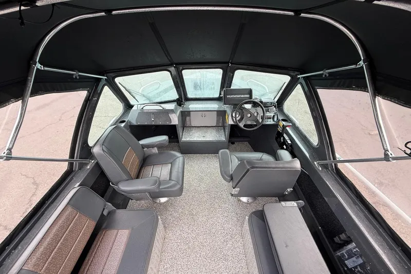 Slide: The Image of 2019 Fish Rite Stalker boat interior with seating and steering console. - 34