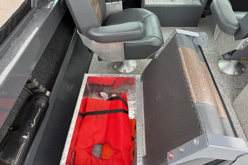 Slide: The Image of 2019 Fish Rite Stalker boat interior with life jacket storage under seat. - 36