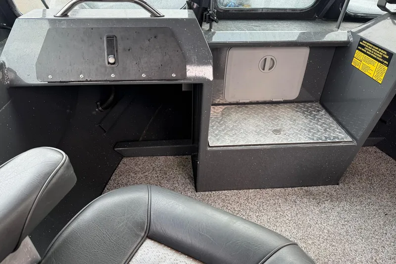 Slide: The Image of 2019 Fish Rite Stalker boat interior with storage compartment and seating. - 39
