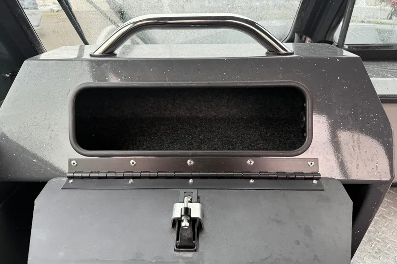 Slide: The Image of 2019 Fish Rite Stalker boat dashboard storage compartment with latch and handle. - 48