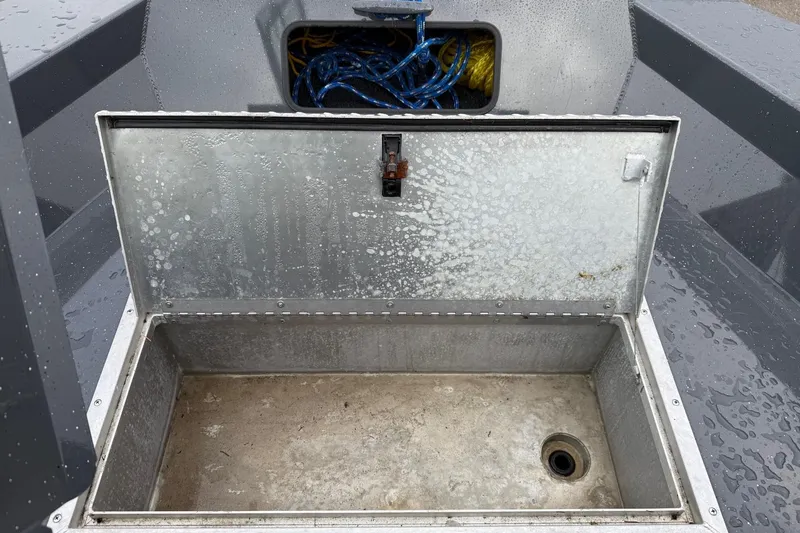 Slide: The Image of Open storage compartment on 2019 Fish Rite Stalker boat, showing interior and coiled ropes. - 50