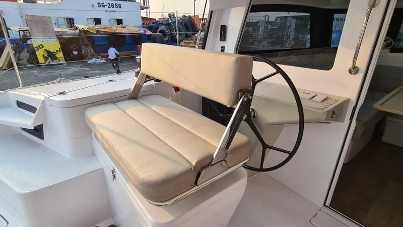 Slide: The Image of 2026 Seawind 1370 yacht helm station with cushioned seating and steering wheel. - 10