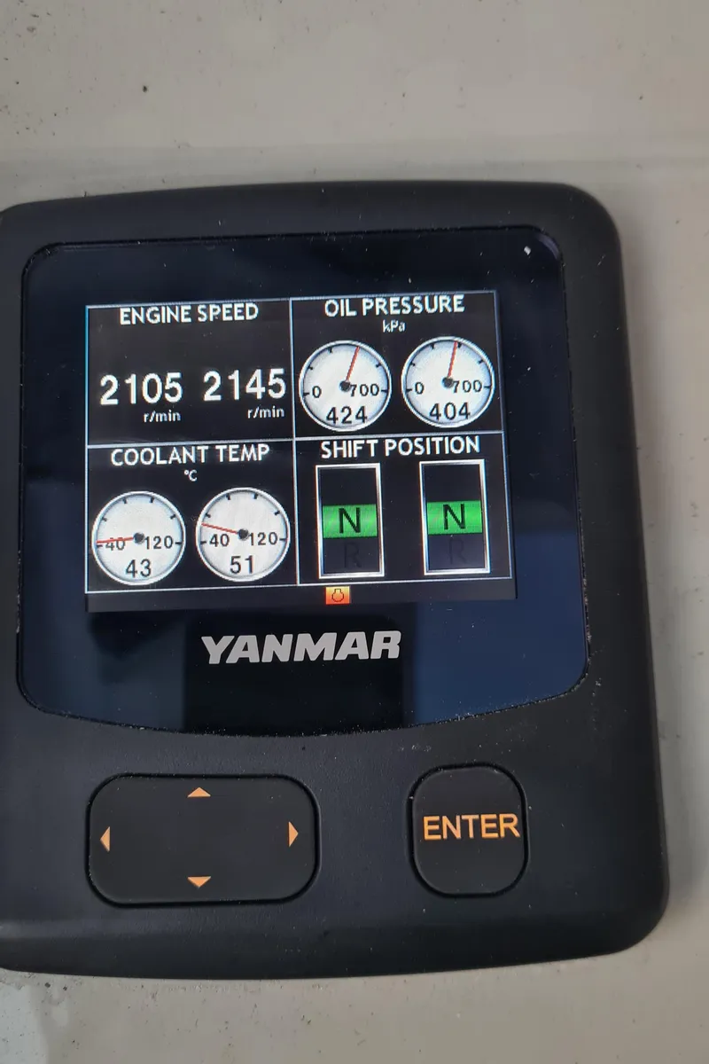 Slide: The Image of Yanmar engine display showing speed, oil pressure, coolant temperature, and shift position on Seawind 1370. - 13