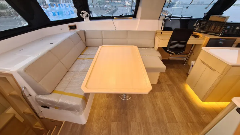 Slide: The Image of 2026 Seawind 1370 yacht interior with modern seating, table, and navigation station. - 15