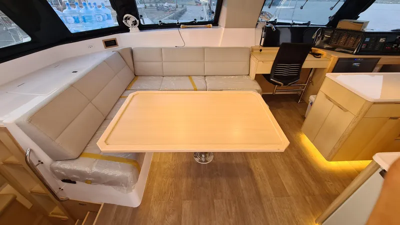 Slide: The Image of Interior of 2026 Seawind 1370 catamaran with modern seating, table, and navigation area. - 16