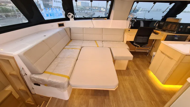 Slide: The Image of Luxurious interior of 2026 Seawind 1370 yacht with modern seating and workspace. - 17