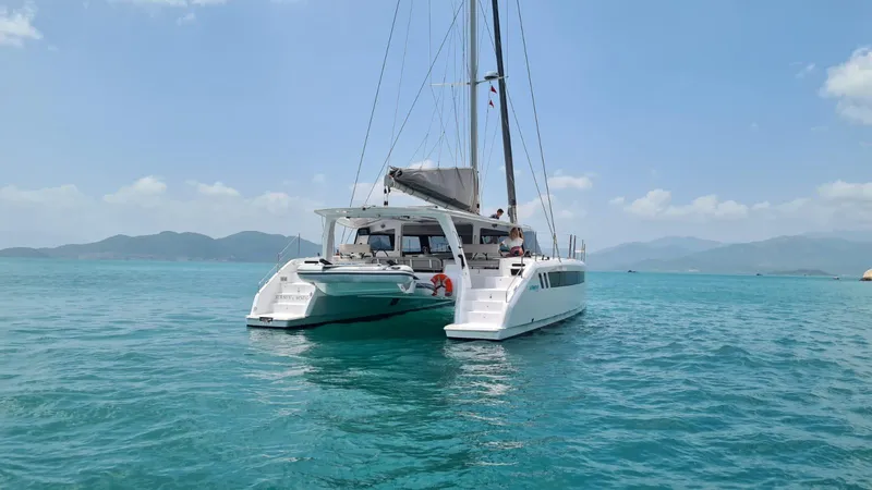 Slide: The Image of 2026 Seawind 1370 catamaran sailing on clear blue waters under a sunny sky. - 2