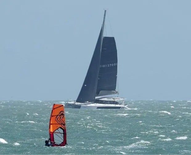 Slide: The Image of Sailboat Seawind 1370 (2026) and windsurfer on choppy sea. - 7