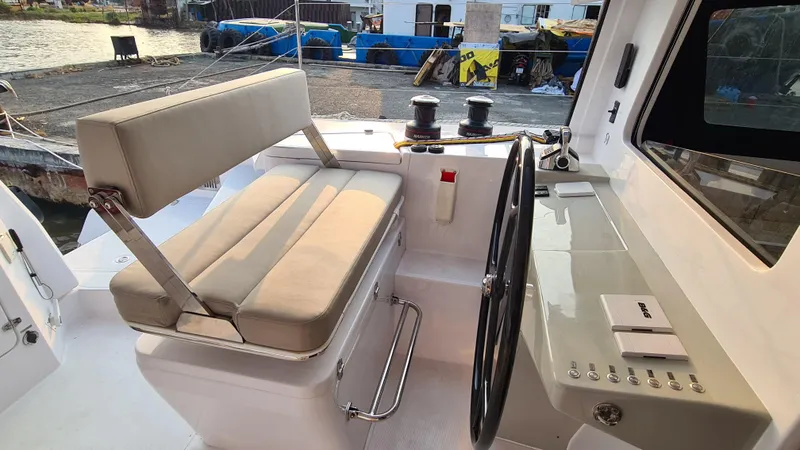 Slide: The Image of Helm station of 2026 Seawind 1370 catamaran with cushioned seating and steering wheel. - 9