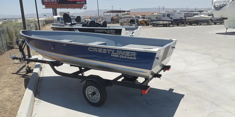 Slide: The Image of 2023 Crestliner 1469 Outreach boat on trailer in outdoor dealership lot. - 3
