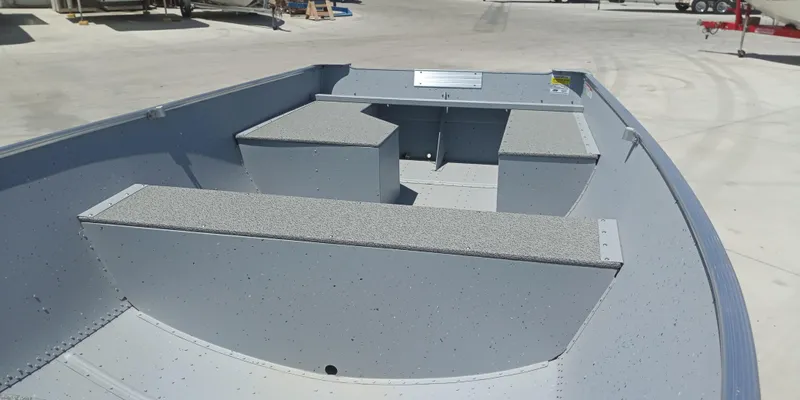 Slide: The Image of 2023 Crestliner 1469 Outreach boat interior with seating and storage compartments. - 4