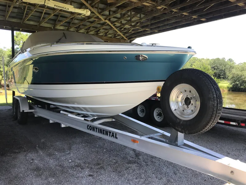 Slide: The Image of 2005 Formula 280 Sun Sport boat cruising on open water. - 2