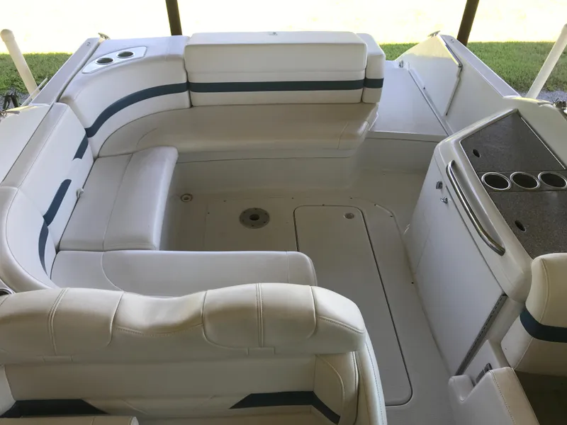 Slide: The Image of 2005 Formula 280 Sun Sport boat on trailer by a lake under clear blue sky. - 6