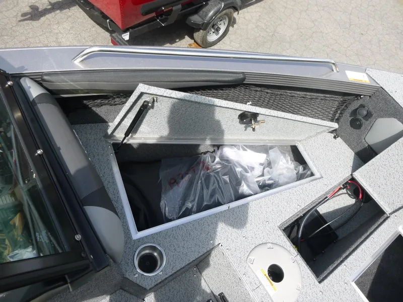 Slide: The Image of Open storage compartment on a 2021 Lund 1975 Tyee boat, showing interior details. - 10