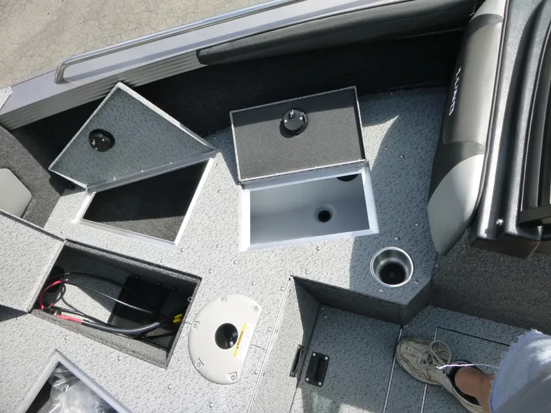 Slide: The Image of Interior view of a 2021 Lund 1975 Tyee boat, showcasing storage compartments and seating. - 11