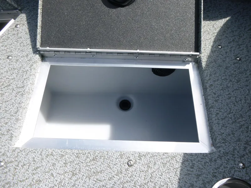 Slide: The Image of Open storage compartment on 2021 Lund 1975 Tyee boat, featuring textured flooring. - 12