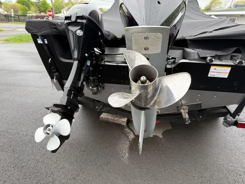 Slide: The Image of Rear view of a 2021 Lund 1975 Tyee boat with dual outboard motors. - 15