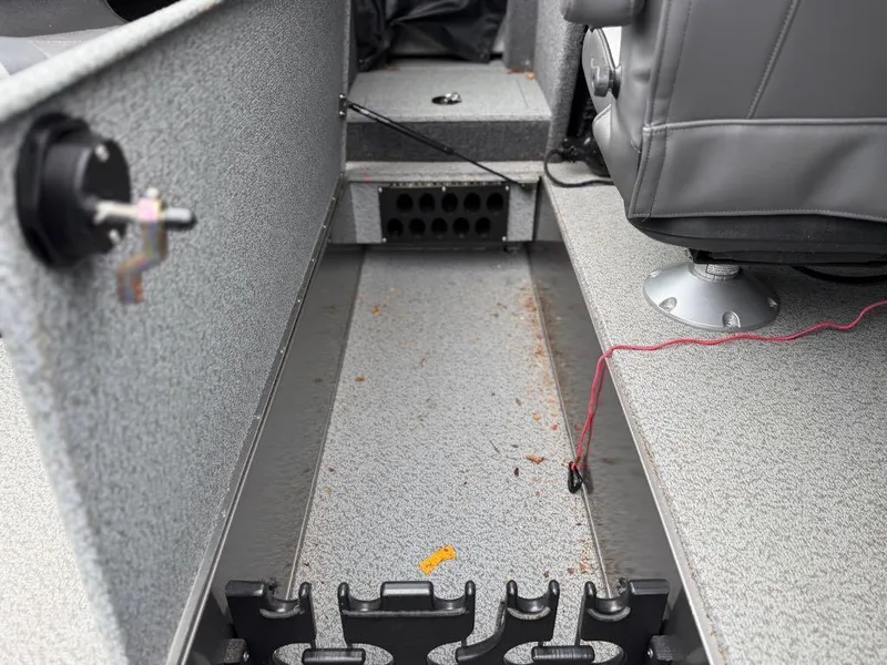 Slide: The Image of Interior of a 2021 Lund 1975 Tyee boat showing storage compartments and seating. - 17