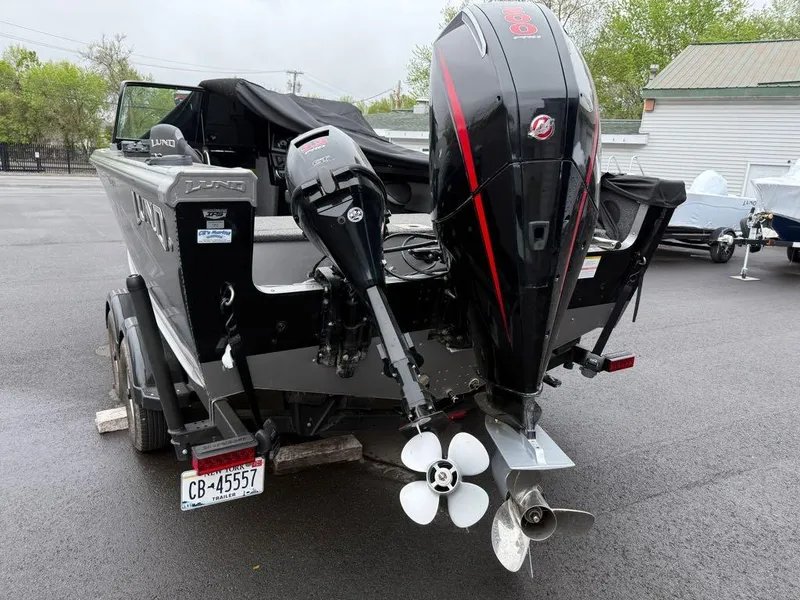Slide: The Image of 2021 Lund 1975 Tyee boat with dual outboard motors on a trailer. - 18