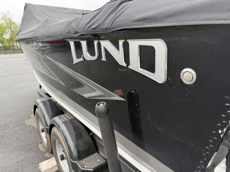 Slide: The Image of Black 2021 Lund 1975 Tyee boat on trailer, covered and parked outdoors. - 21