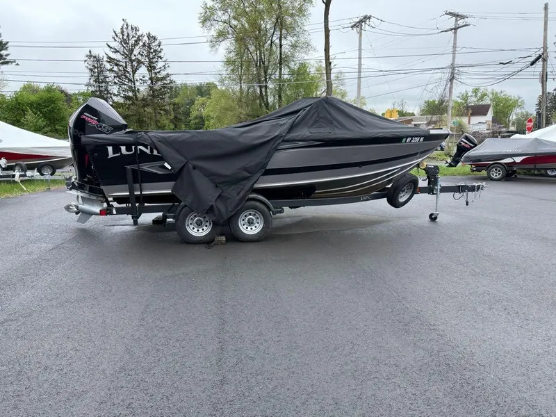 Slide: The Image of 2021 Lund 1975 Tyee boat on trailer, covered, parked outdoors. - 22