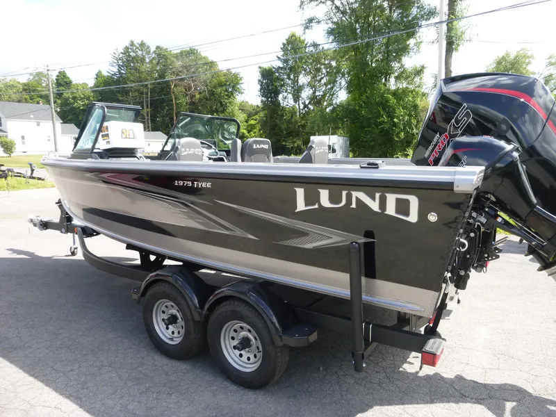 Slide: The Image of Lund 1975 Tyee boat, 2021 model, on a trailer in a sunny outdoor setting. - 25