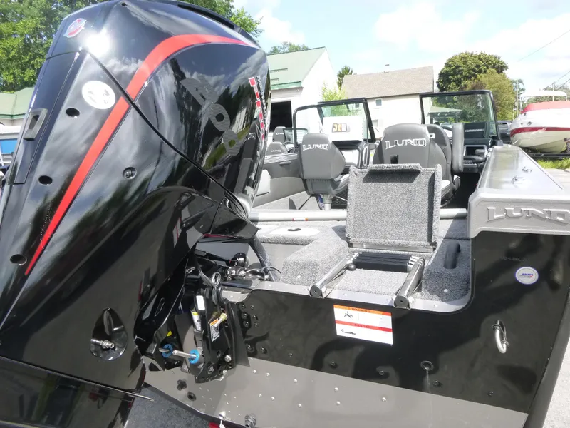 Slide: The Image of 2021 Lund 1975 Tyee boat with powerful outboard motor, sleek design, and spacious seating. - 27