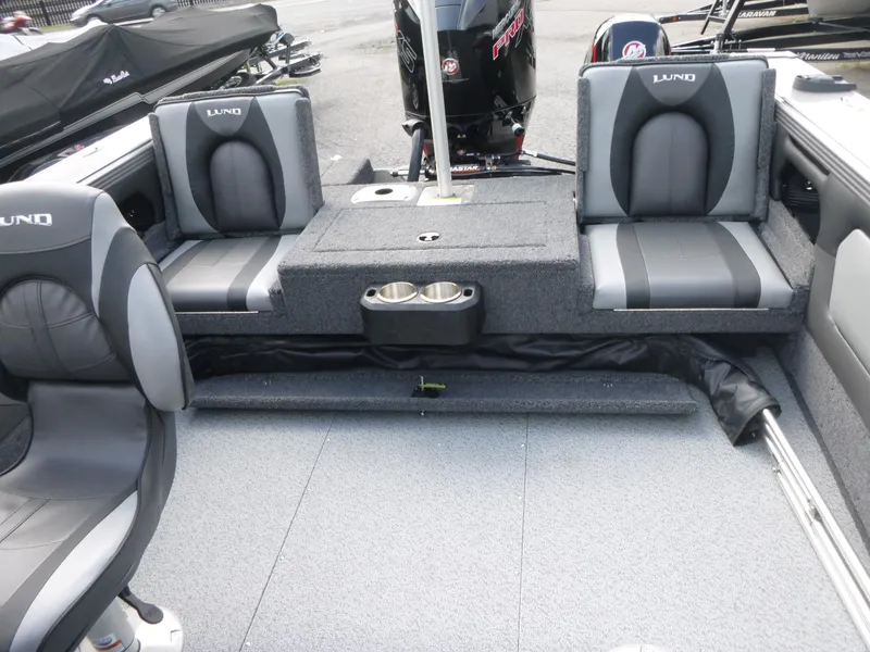 Slide: The Image of Interior of a 2021 Lund 1975 Tyee boat with gray seating and cup holders. - 29