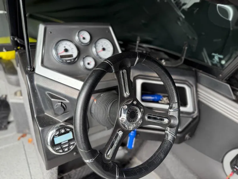 Slide: The Image of Interior of a 2021 Lund 1975 Tyee boat showing steering wheel and dashboard controls. - 3