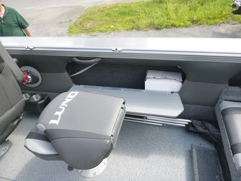 Slide: The Image of Interior of a 2021 Lund 1975 Tyee boat, featuring seating and storage compartments. - 30