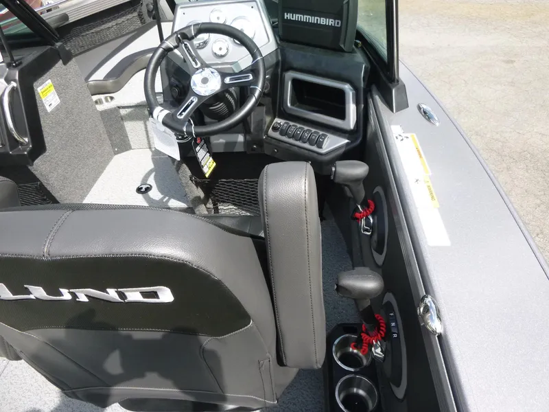 Slide: The Image of Interior of 2021 Lund 1975 Tyee boat with steering wheel and control panel. - 32