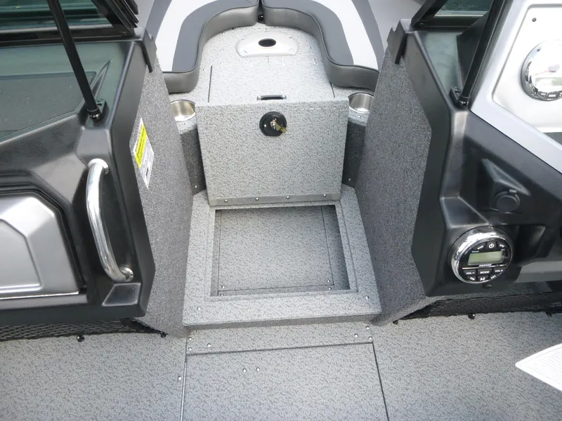 Slide: The Image of Interior of 2021 Lund 1975 Tyee boat, featuring storage compartment and control panel. - 34