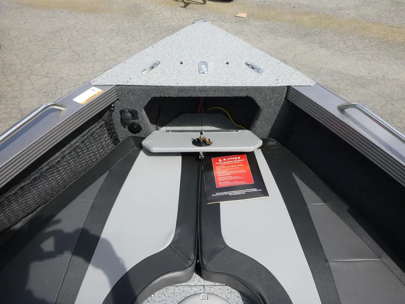 Slide: The Image of Interior of a 2021 Lund 1975 Tyee boat, featuring seating and storage compartments. - 35