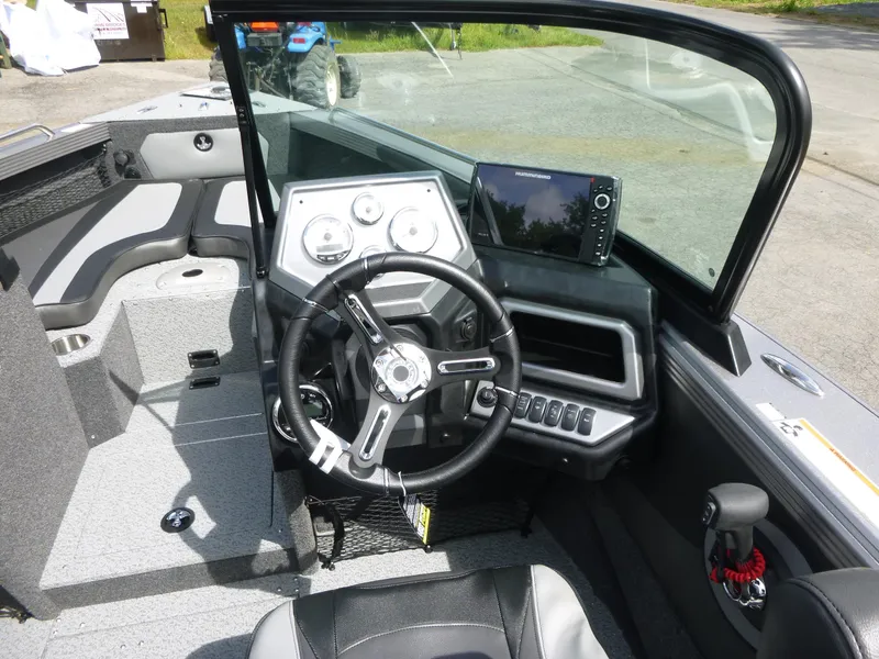 Slide: The Image of Interior of 2021 Lund 1975 Tyee boat with steering wheel and control panel. - 36