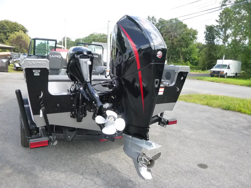 Slide: The Image of 2021 Lund 1975 Tyee boat with powerful outboard motor, parked outdoors. - 38