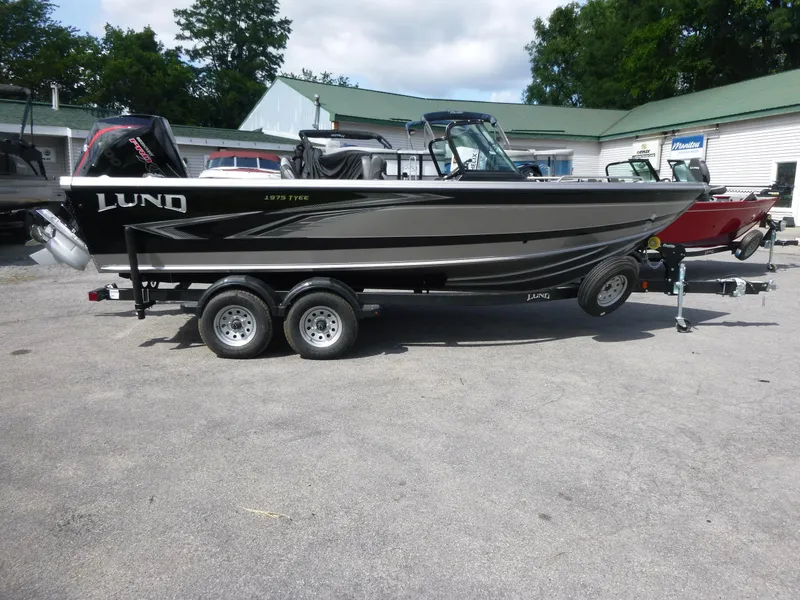 Slide: The Image of Lund 1975 Tyee boat on trailer, 2021 model, parked outdoors. - 4