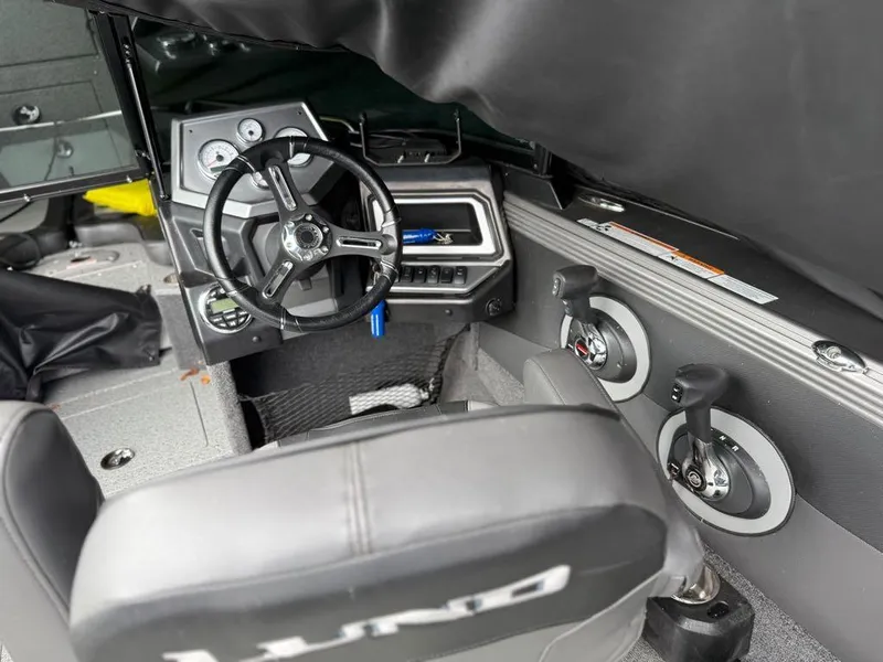 Slide: The Image of Interior of a 2021 Lund 1975 Tyee boat showing steering wheel and controls. - 40