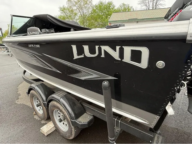 Slide: The Image of 2021 Lund 1975 Tyee boat on trailer, black exterior with silver accents. - 42