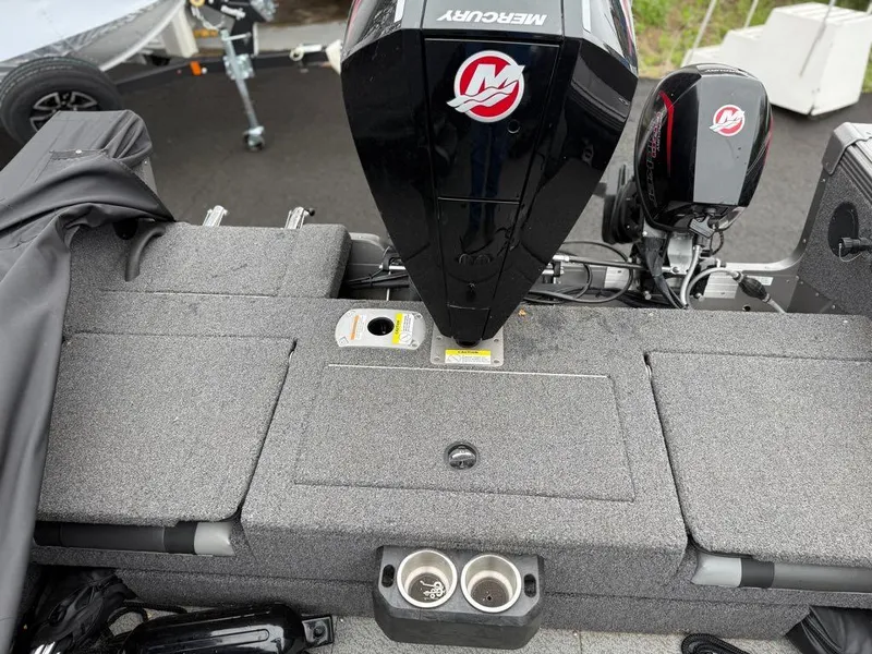 Slide: The Image of 2021 Lund 1975 Tyee boat with Mercury outboard motor, gray deck, and cup holders. - 44